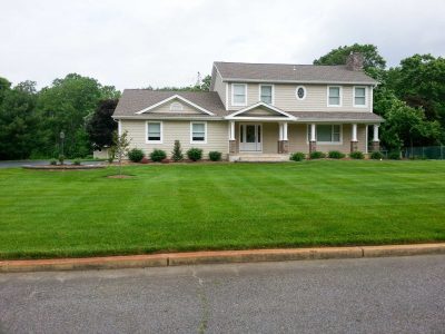 Plush lawn in front yard, walkway and newly planted beds